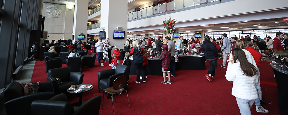 People milling about the buffets with leather chairs grouped together around small tables